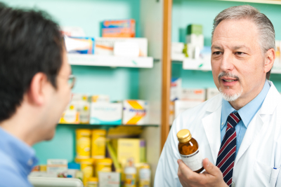 A customer asking for a medicine to a pharmacist