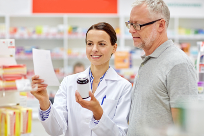 happy pharmacist and senior man customer with drug and prescription at drugstore