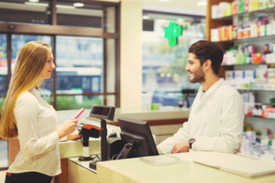 pharmacist counseling female customer in pharmacy